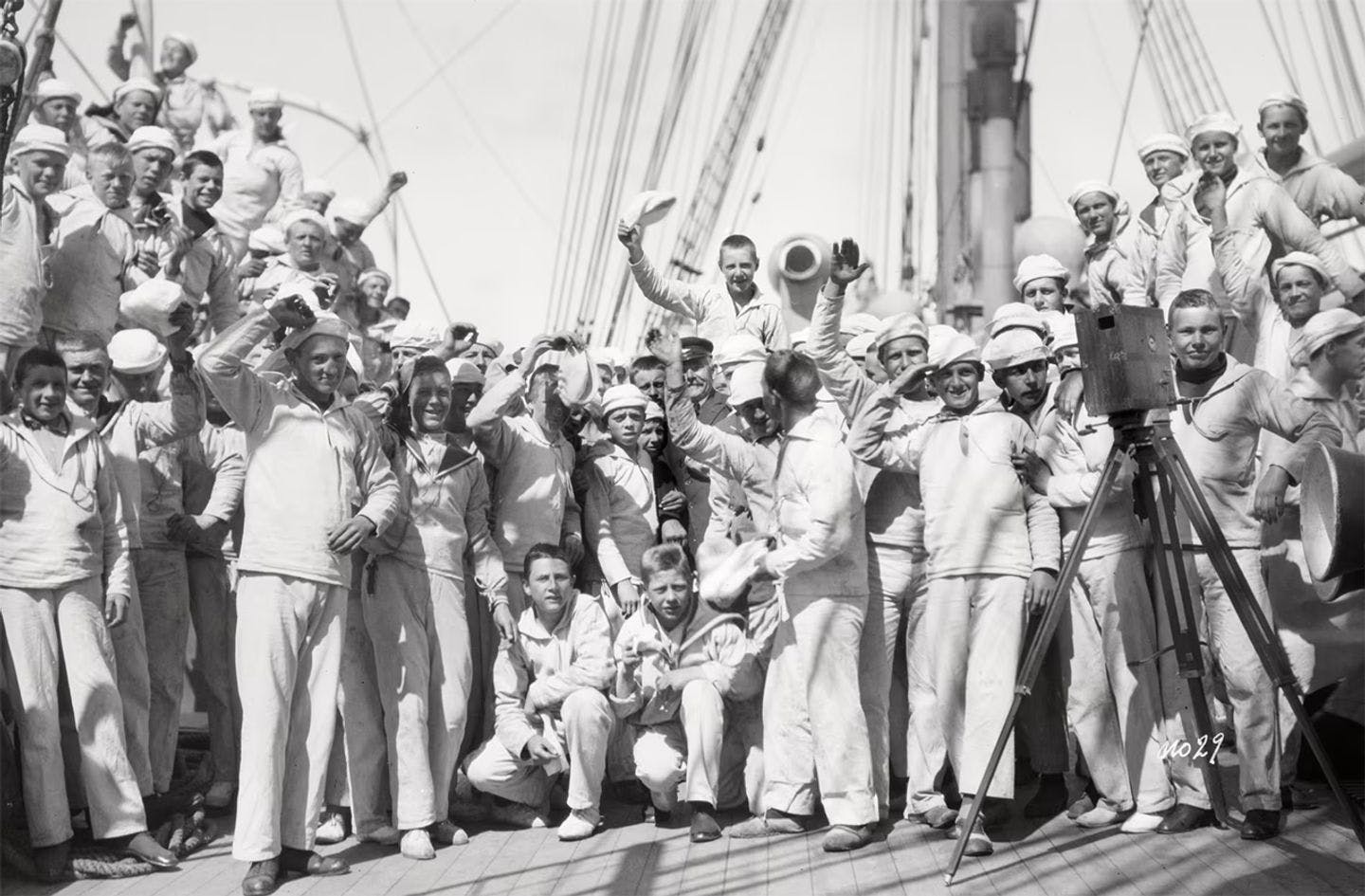 A merry gang on board the «Statsraad Lehmkuhl». Probably in 1923. Despite the cheerful picture, there were harsh conditions on board. The discipline was tough, and so were the punishments. A common crime was to steal from the boys who could buy extra food. If the food thief was caught, the penalty was to "run the rig" all the way to the top on one side and down the other. The worse the crime, the more times you were sent up. Photo: UiB